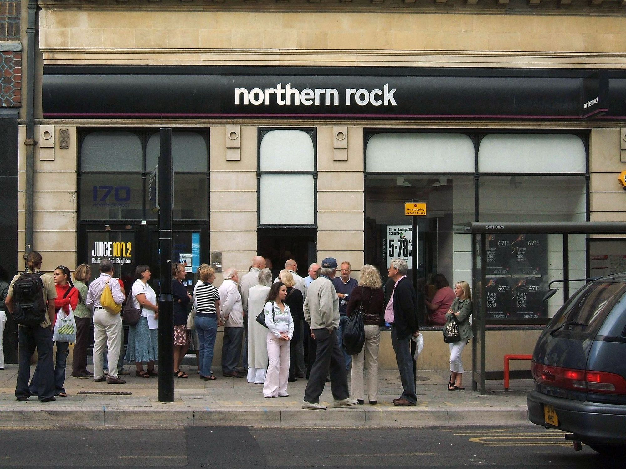 Small line of customers (presumably anxious investors and savers) outside a branch of Northern Rock - a Mortgage specialist and a top UK mortgage lender - in North Street, Brighton, East Sussex. The business (a former "savings and loan" type Building Society which was demutualised in 1997) has been affected in part by problems in the US "subprime" lending market.