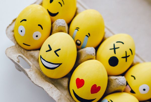 Yellow painted emoticon eggs